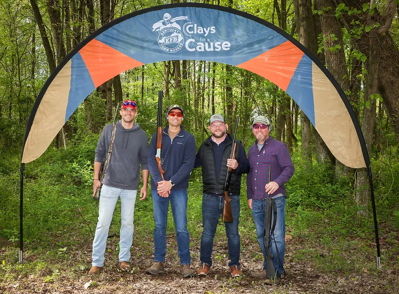 Four men under Clays for a Cause banner