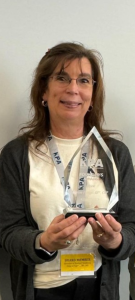 A woman holding an award.