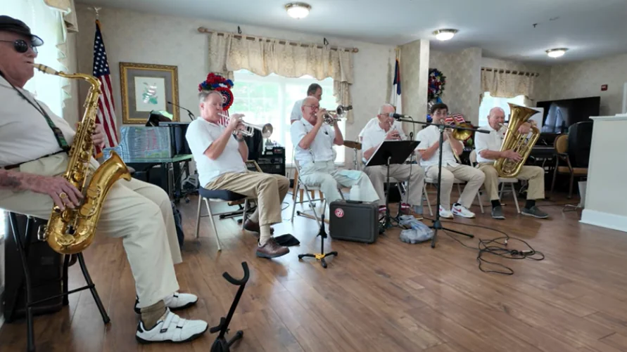 Britton Fugazzi plays trombone with other musicians